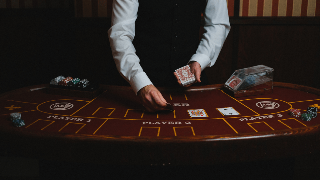 a person in a suit is playing cards on a casino table