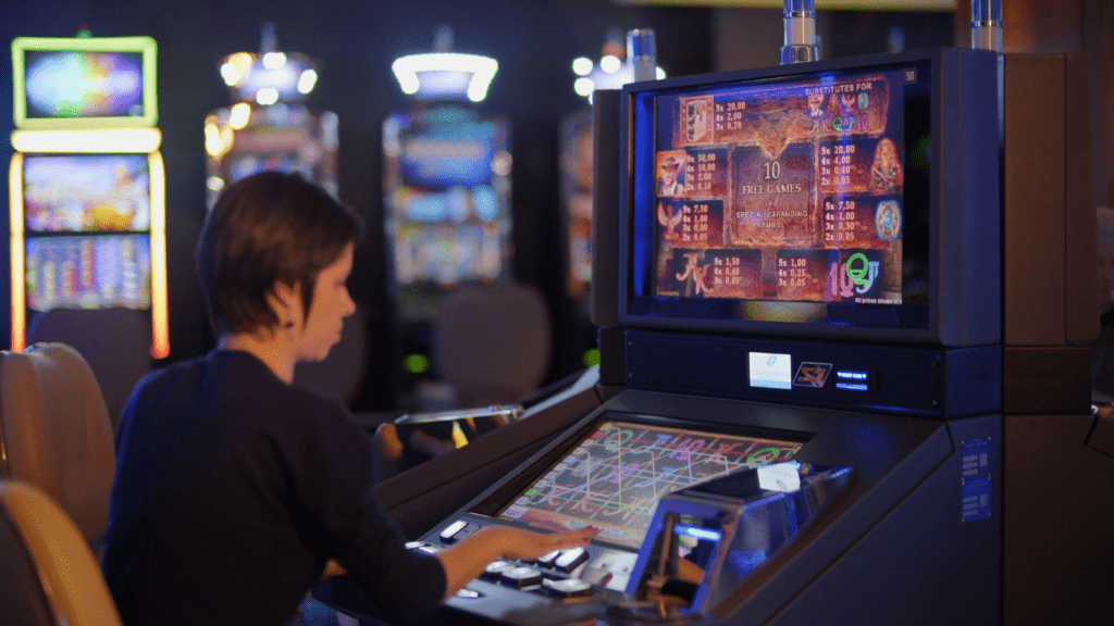 a person playing a slot machine in a casino