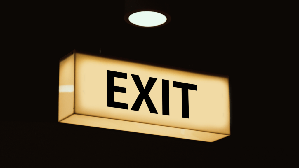 an exit sign is lit up in the dark