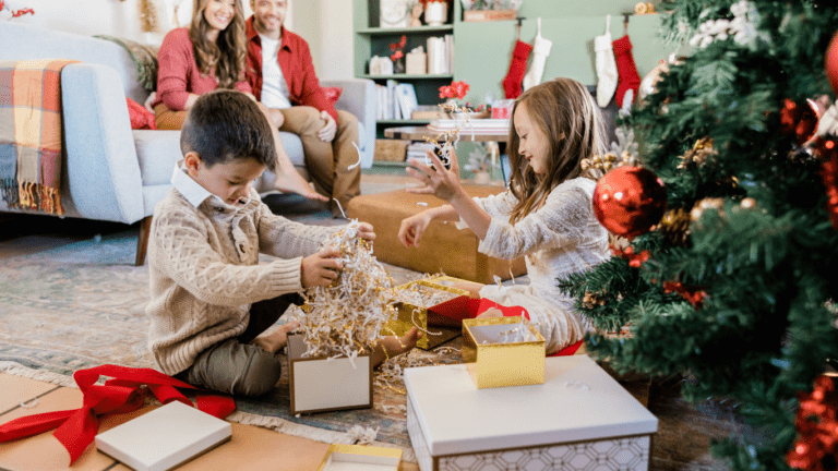 a family sitting around a christmas tree with presents