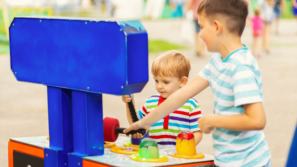 children playing with an arcade machine