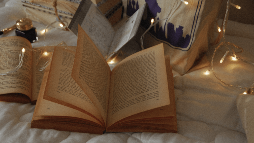 Open books on a bed