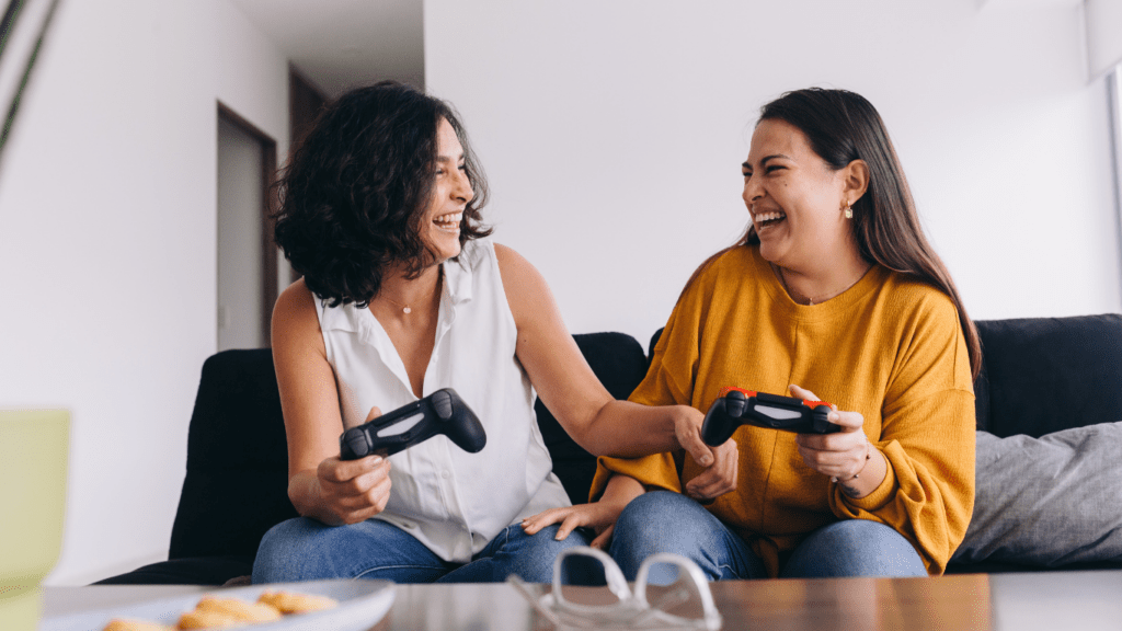 two people sitting on a couch playing video games