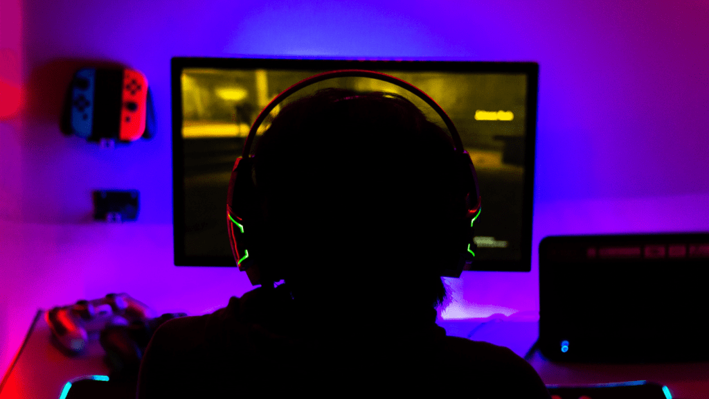 a person playing video games in a dark room