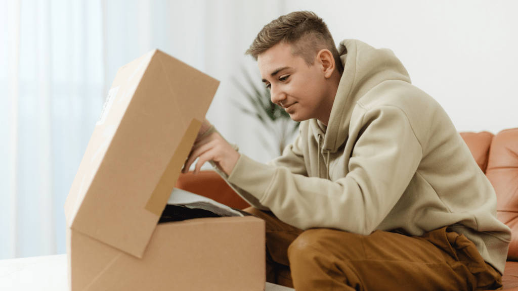 a person sitting on a couch with a box in front of them