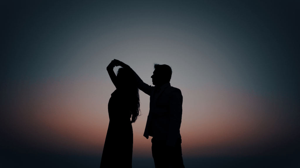 silhouette of a couple dancing on the beach at sunset