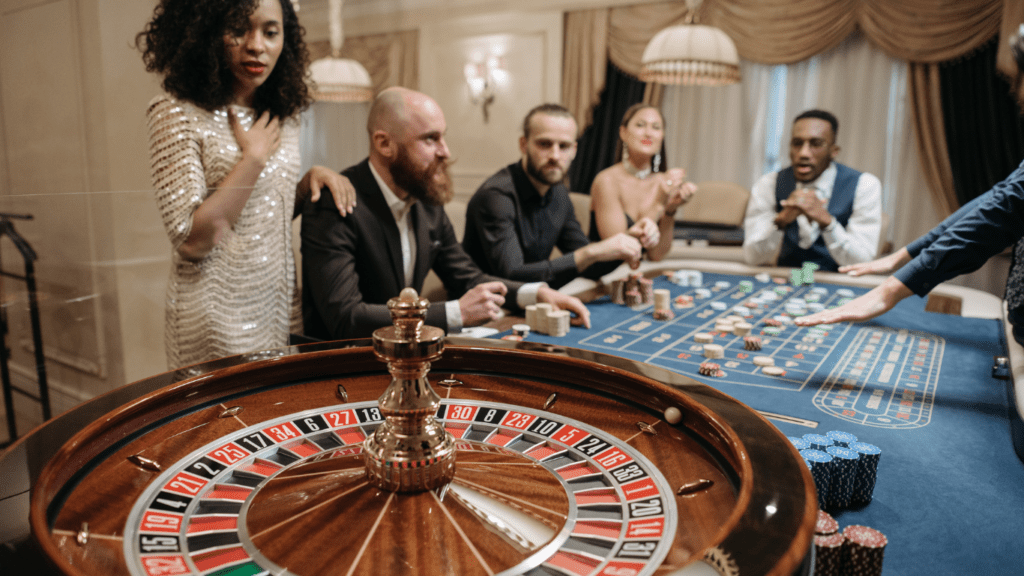 a group of people playing roulette in a casino