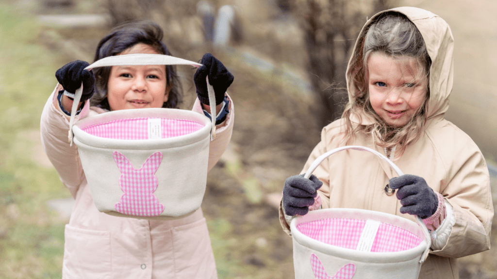 a child in a pink coat holding a bucket of pink paint