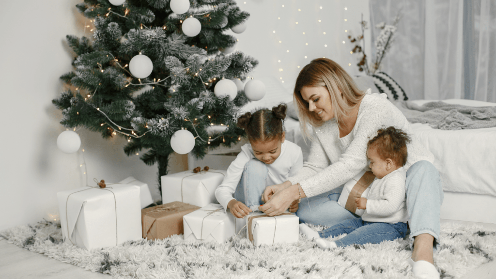 a family sitting around a christmas tree with presents