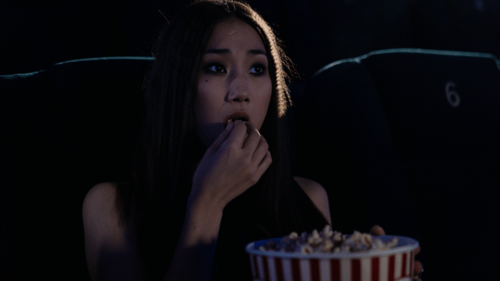 a person eating a popcorn