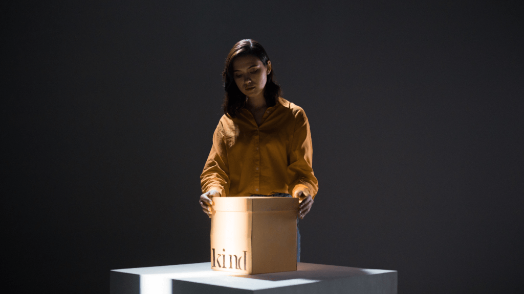 a person holding a brown box