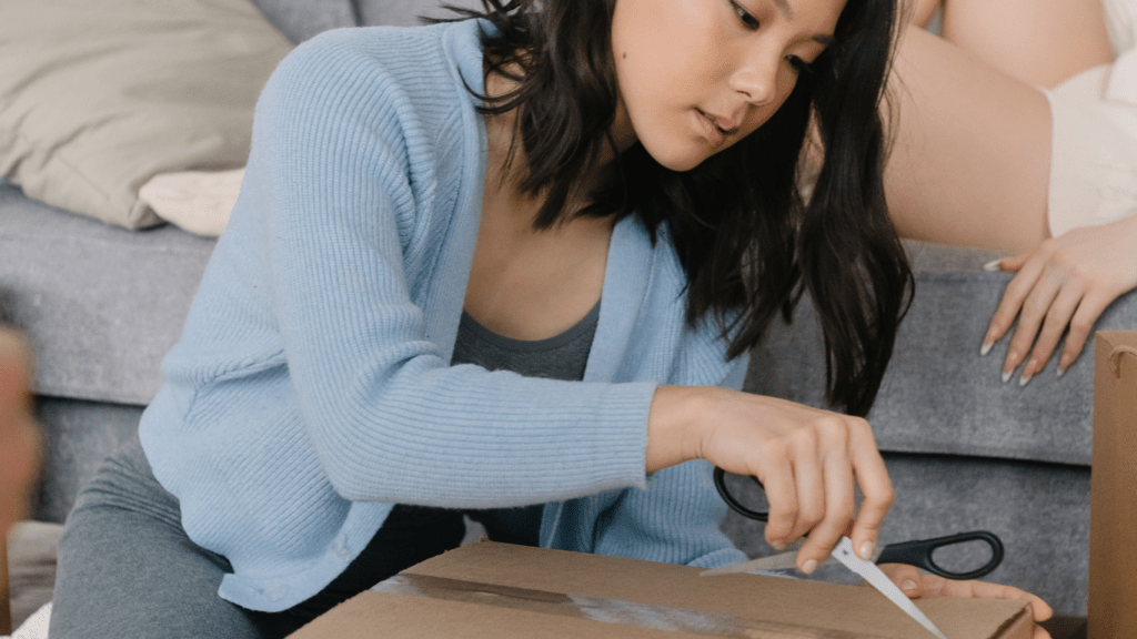 a person holding a scissor