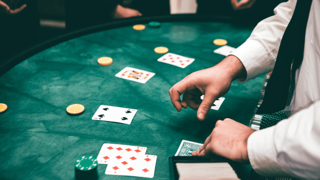 a person in a suit is playing cards on a casino table