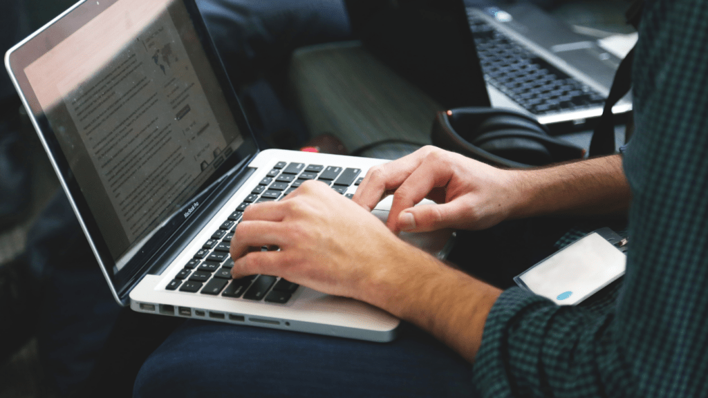 a person is working on a computer in front of a monitor