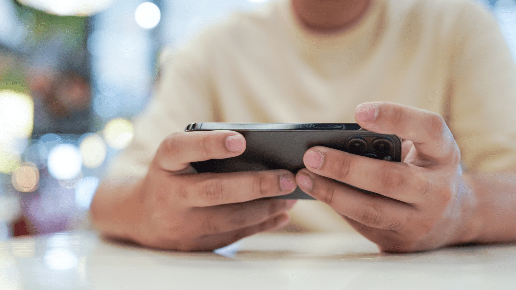 a person sitting on a couch looking at a phone