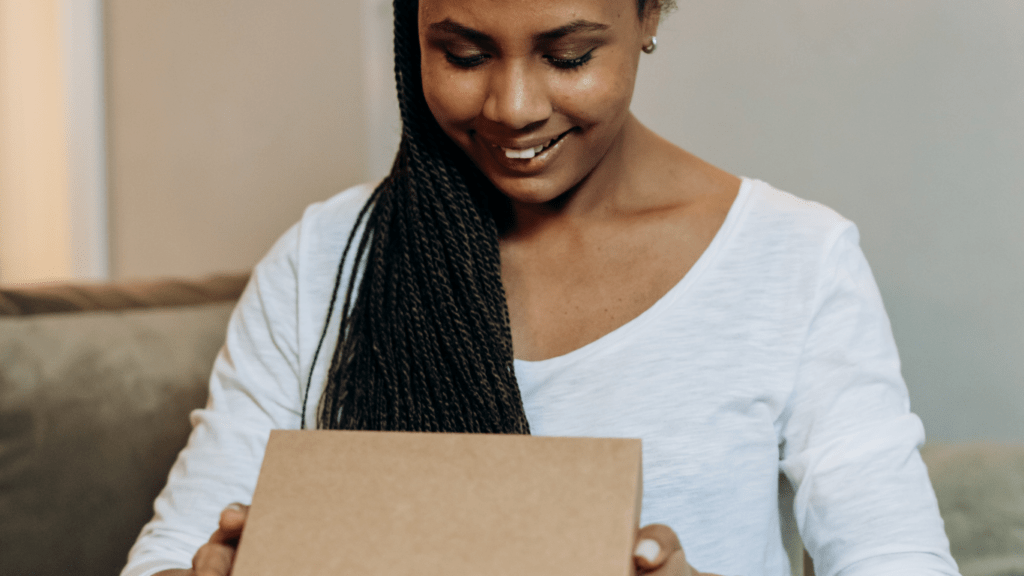 a person sitting on a couch with a box in front of them