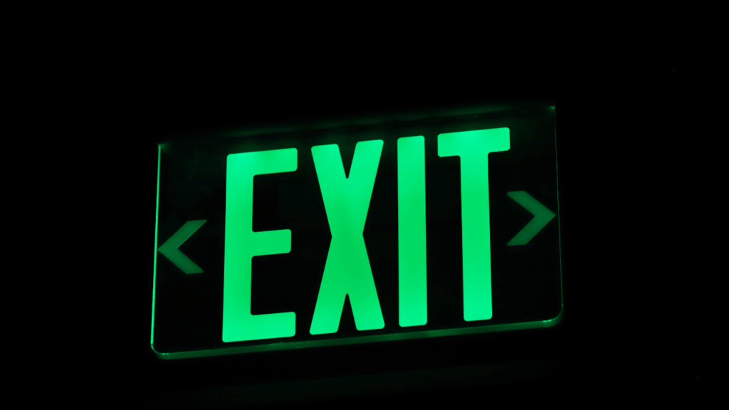 an exit sign is lit up in the dark