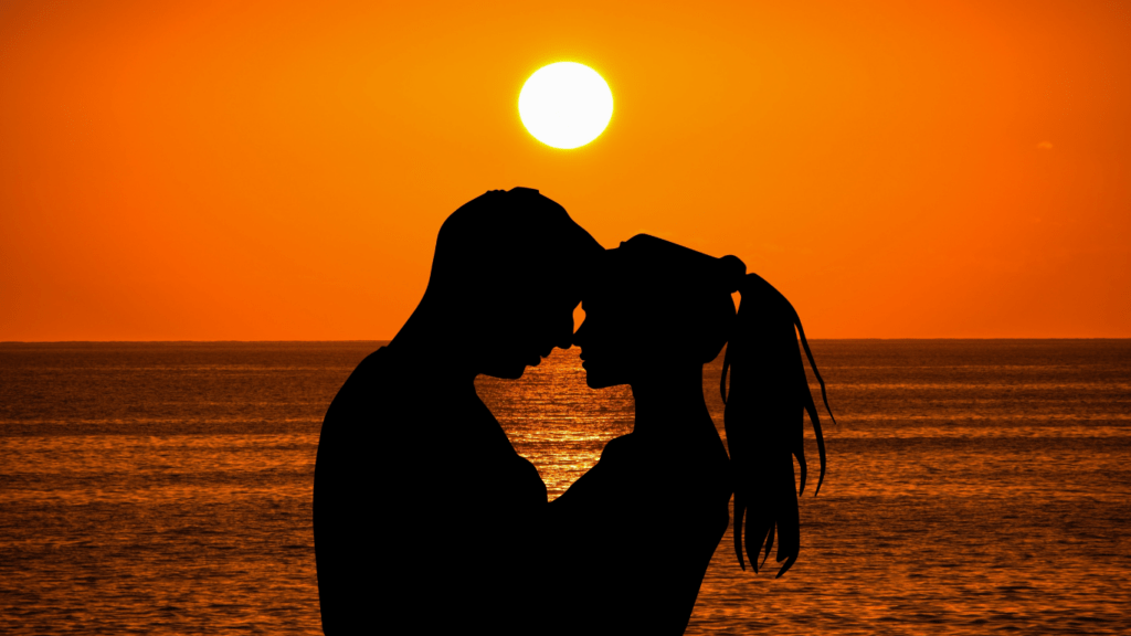 silhouette of a couple dancing on the beach at sunset